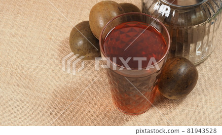 Monk fruit or Luo Han Guo. Dried fruits for healthy sweetener drink. Natural herbal remedy and glass bottle background. Monk fruit drink for who concern health and sugar substitute. Monk fruit or Luo Han Guo. Dried fruits for healthy sweetener drink. Natural herbal remedy and glass bottle background. Monk fruit drink for who concern health and sugar substitute. 81943528