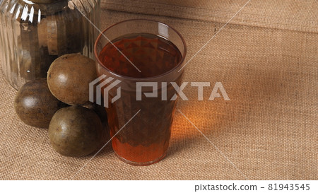 Monk fruit or Luo Han Guo. Dried fruits for healthy sweetener drink. Natural herbal remedy and glass bottle background. Monk fruit drink for who concern health and sugar substitute. 81943545