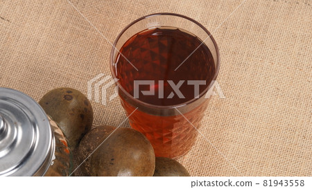 Monk fruit or Luo Han Guo. Dried fruits for healthy sweetener drink. Natural herbal remedy and glass bottle background. Monk fruit drink for who concern health and sugar substitute. 81943558