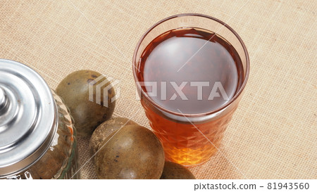 Monk fruit or Luo Han Guo. Dried fruits for healthy sweetener drink. Natural herbal remedy and glass bottle background. Monk fruit drink for who concern health and sugar substitute. 81943560