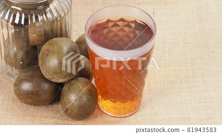 Monk fruit or Luo Han Guo. Dried fruits for healthy sweetener drink. Natural herbal remedy and glass bottle background. Monk fruit drink for who concern health and sugar substitute. Monk fruit or Luo Han Guo. Dried fruits for healthy sweetener drink. Natural herbal remedy and glass bottle background. Monk fruit drink for who concern health and sugar substitute. 81943583