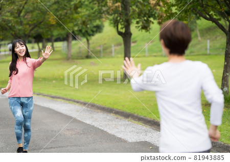 Two women waving their hands while jogging Two women waving their hands while jogging 81943885
