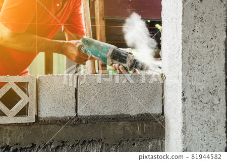 Man worker electric drill make cement pole structure of home Man worker electric drill make cement pole structure of home 81944582