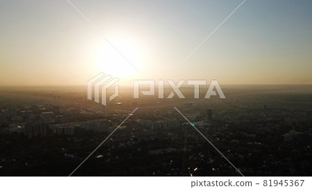 Bright yellow sun over the city of Almaty. Bright yellow sun over the city of Almaty. 81945367