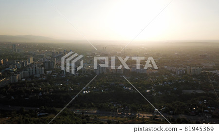 Bright yellow sun over the city of Almaty. Bright yellow sun over the city of Almaty. 81945369