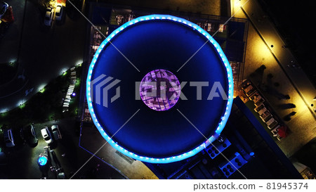 The round roof glows blue in the dark. 81945374