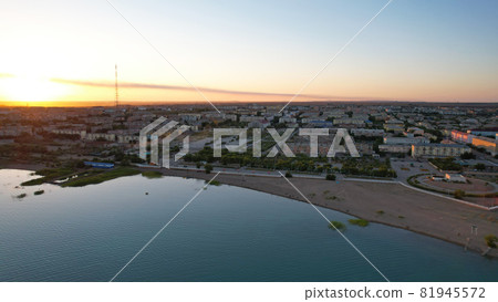 A lake, a factory and a city at a beautiful sunset A lake, a factory and a city at a beautiful sunset 81945572