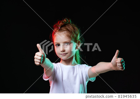 child girl showing Ok gesture on black background. child girl showing Ok gesture on black background. 81945635