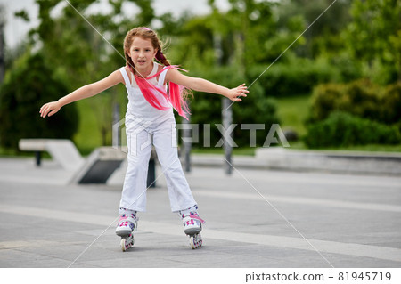 Cute little child girl on roller skates Cute little child girl on roller skates 81945719
