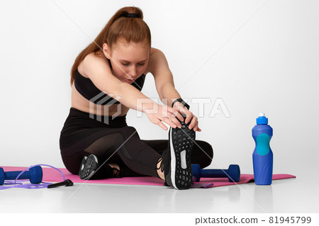 Strong sporty girl in black sportswear working out 81945799