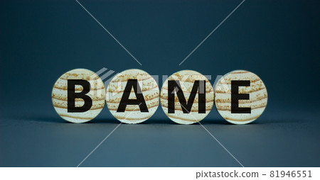 BAME symbol. Abbreviation BAME, black, asian and minority ethnic on wooden circles. Beautiful grey background. Copy space. Business and BAME, black, asian and minority ethnic concept. 81946551