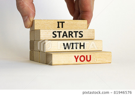 It starts with you symbol. Wooden blocks with words 'it starts with you' on beautiful white background. Businessman hand. Business, motivational and it starts with you concept. Copy space. It starts with you symbol. Wooden blocks with words 'it starts with you' on beautiful white background. Businessman hand. Business, motivational and it starts with you concept. Copy space. 81946576