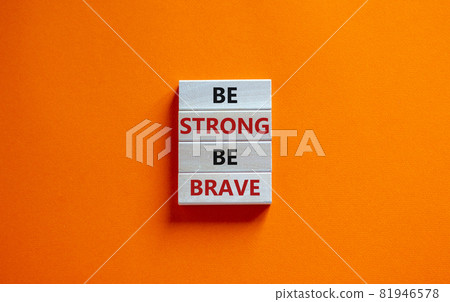 Be strong be brave symbol. Wooden blocks with words 'be strong be brave'. Beautiful orange background. Copy space. Motivational, business and strong brave concept. Be strong be brave symbol. Wooden blocks with words 'be strong be brave'. Beautiful orange background. Copy space. Motivational, business and strong brave concept. 81946578