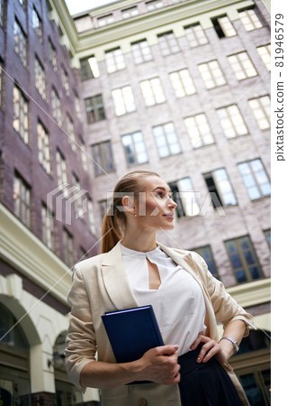 business woman going to work with notebook business woman going to work with notebook 81946579