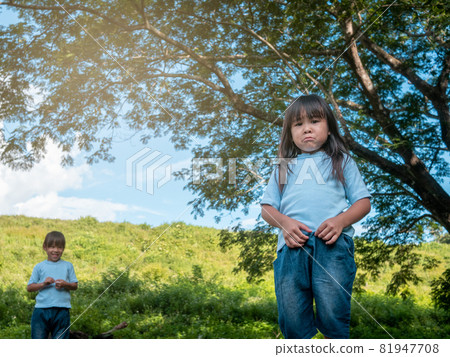 The conflict of the sisters during plays in the garden. Sibling relationship. Problems in family relationships between children. 81947708
