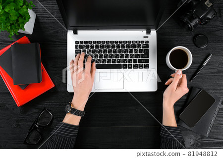 Mix of office supplies and gadgets on a wooden desk background. View from above. Mix of office supplies and gadgets on a wooden desk background. View from above. 81948812