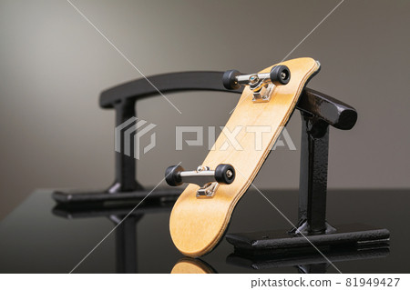 Fingerboard on a metal railing of black color, close-up 81949427