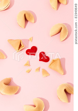 Creative composition with fortune cookies and hearts on pink background 81949649