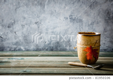 Cup of tea or coffee with autumn leaf Cup of tea or coffee with autumn leaf 81950106