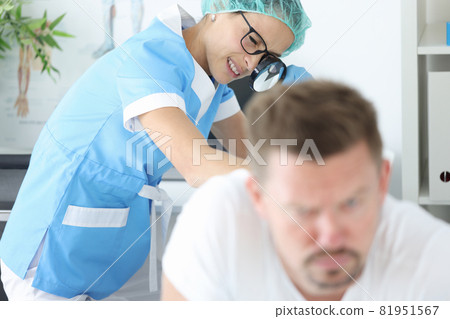 Woman doctor with glasses examining rash on skin of buttocks of young man in clinic Woman doctor with glasses examining rash on skin of buttocks of young man in clinic 81951567