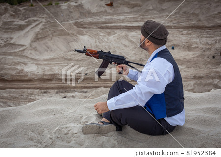 A Taliban soldier monitors a road in Afghanistan. 81952384