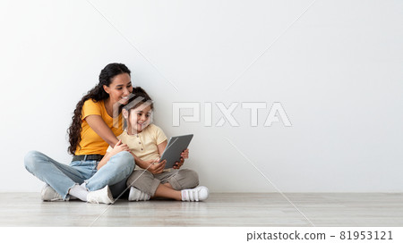 Online Offer. Smiling Arab Mother And Little Daughter Using Digital Tablet Together 81953121