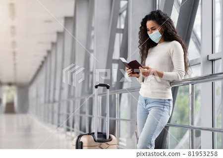 Young Woman Wearing Medical Mask Waiting For Flight In Airport Terminal 81953258