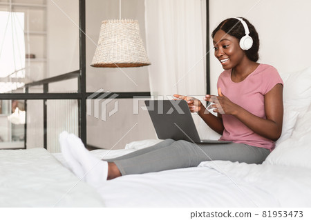 African American Lady Making Video Call Using Laptop At Home African American Lady Making Video Call Using Laptop At Home 81953473
