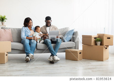 Happy man woman and kid using laptop after relocation 81953614