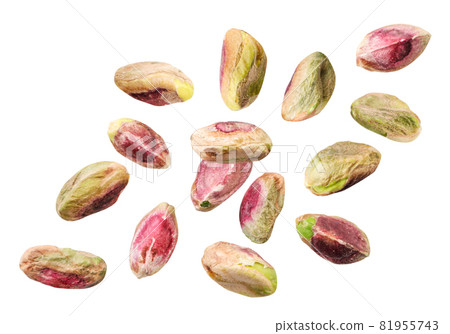 Peeled pistachios fall on a white background, levitating cut pistachios. Isolated Peeled pistachios fall on a white background, levitating cut pistachios. Isolated 81955743