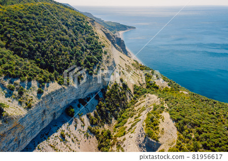 Aerial view of coastline with sea, mountains, canyon and cliffs with daylight Aerial view of coastline with sea, mountains, canyon and cliffs with daylight 81956617