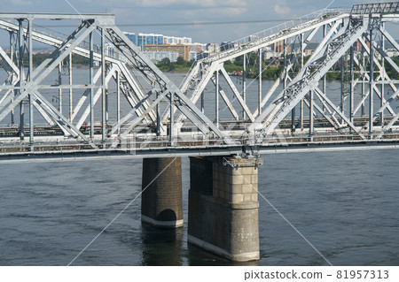 Arch of a railway bridge over a river in an industrial city. Arch of a railway bridge over a river in an industrial city. 81957313