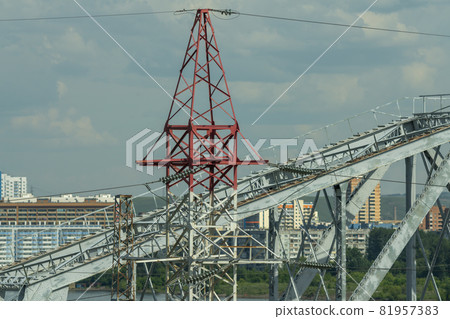 Electric pole against the background of the arch of the railway bridge. Electric pole against the background of the arch of the railway bridge. 81957383