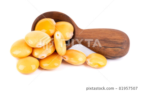 Pickled yellow lupine beans in wooden spoon, isolated on white background. Tournus, preserved lupinus. Pickled yellow lupine beans in wooden spoon, isolated on white background. Tournus, preserved lupinus. 81957507