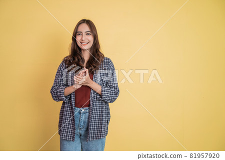 attractive woman smiling while clapping while looking at camera with copyspace attractive woman smiling while clapping while looking at camera with copyspace 81957920