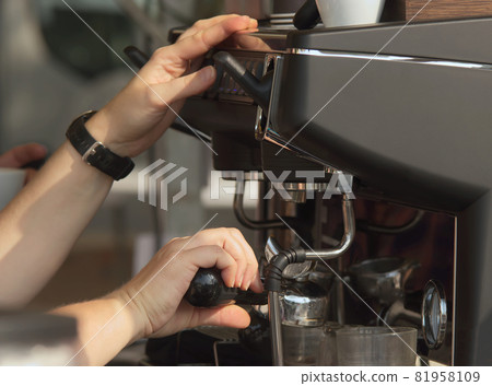 Coffee preparation at a traditional farmers market. A barista prepares fresh espresso at an outdoor market in Prague, Zizkov district. Coffee preparation at a traditional farmers market. A barista prepares fresh espresso at an outdoor market in Prague, Zizkov district. 81958109