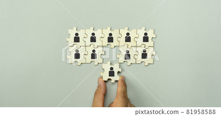 Top view of human resources and recruiting business or team leader concepts. Hand adult Asian man holding of people icon community on wooden cube block. Object on grey paper background. Banner border. Top view of human resources and recruiting business or team leader concepts. Hand adult Asian man holding of people icon community on wooden cube block. Object on grey paper background. Banner border. 81958588