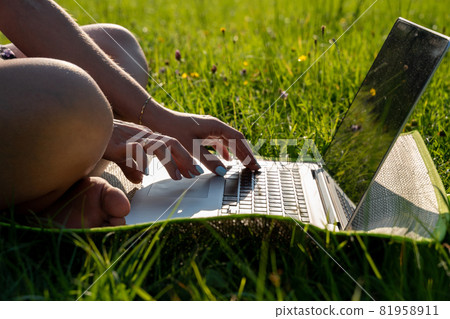 Computer outdoor. Student girl working on laptop, tablet in summer park. Woman person business nature outside with online technology. Electronic gadgets distance learning concept. Computer outdoor. Student girl working on laptop, tablet in summer park. Woman person business nature outside with online technology. Electronic gadgets distance learning concept. 81958911