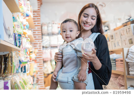 asian mother with her toddler boy shopping in the baby shop asian mother with her toddler boy shopping in the baby shop 81959498
