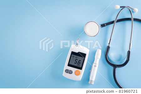Healthcare and medical concept, Stethoscope and blood glucose meter sets on blue background, World Diabetes day, 14 November. 81960721
