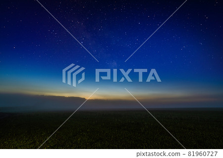 Foggy night field with starry night sky and afterglow horizon gradient 81960727