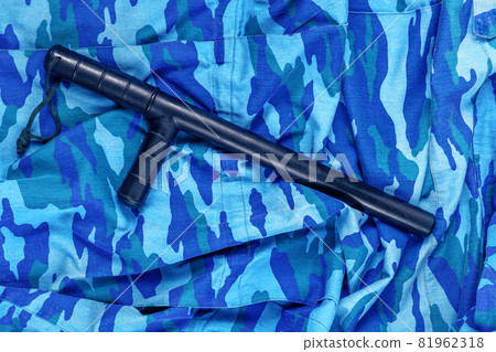black rubber baton on blue urban russian riot police camouflage flat lay black rubber baton on blue urban russian riot police camouflage flat lay 81962318