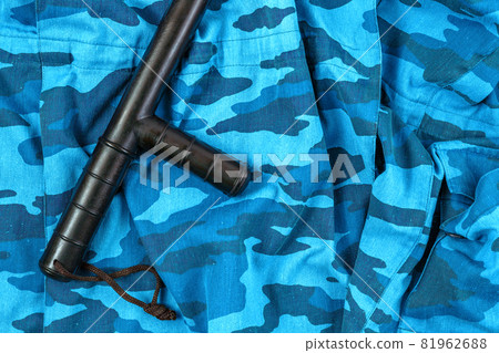 black rubber baton on blue urban russian riot police camouflage flat lay black rubber baton on blue urban russian riot police camouflage flat lay 81962688