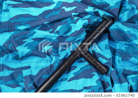 black rubber baton on blue urban russian riot police camouflage flat lay 81962740