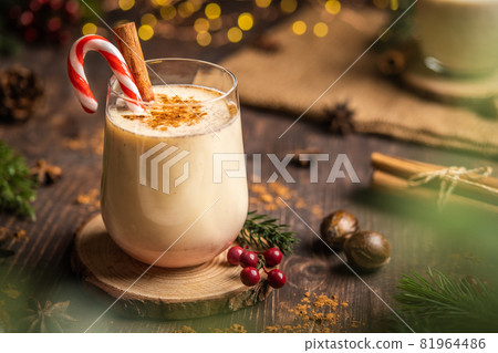 Eggnog with spicy cinnamon.Christmas and winter holidays,Cozy cocktail with cinnamon and candy cane,Traditional Christmas drink with grated nutmeg and cinnamon,Homemade Holiday drink Eggnog with spicy cinnamon.Christmas and winter holidays,Cozy cocktail with cinnamon and candy cane,Traditional Christmas drink with grated nutmeg and cinnamon,Homemade Holiday drink 81964486