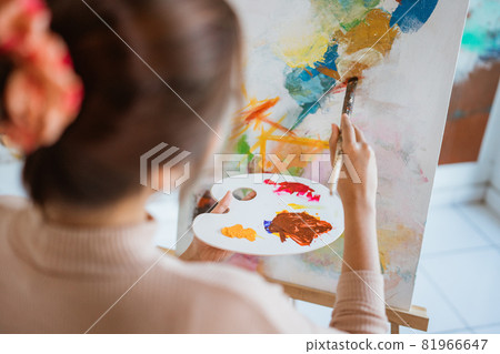 painter artist painting on canvas shoot from her back painter artist painting on canvas shoot from her back 81966647