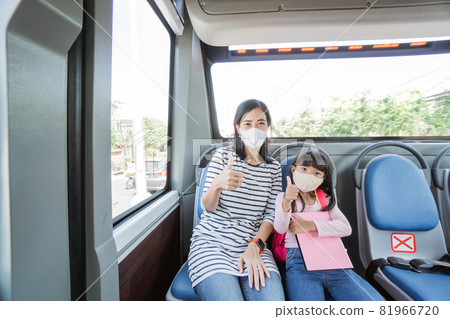 asian mother taking her daughter to school by riding bus public transport wearing a face mask asian mother taking her daughter to school by riding bus public transport wearing a face mask 81966720