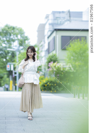 A woman walking outdoors A woman walking outdoors 81967566