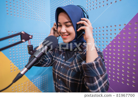muslim woman girl is recording a podcast in her studio 81967700