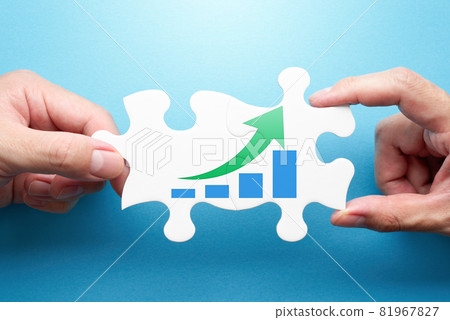 A solution to growth problems. Two hands connecting a graph and a puzzle with a rising arrow. 81967827